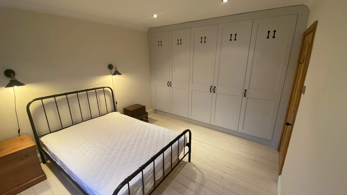 Fitted grey shaker wardrobes in a bedroom